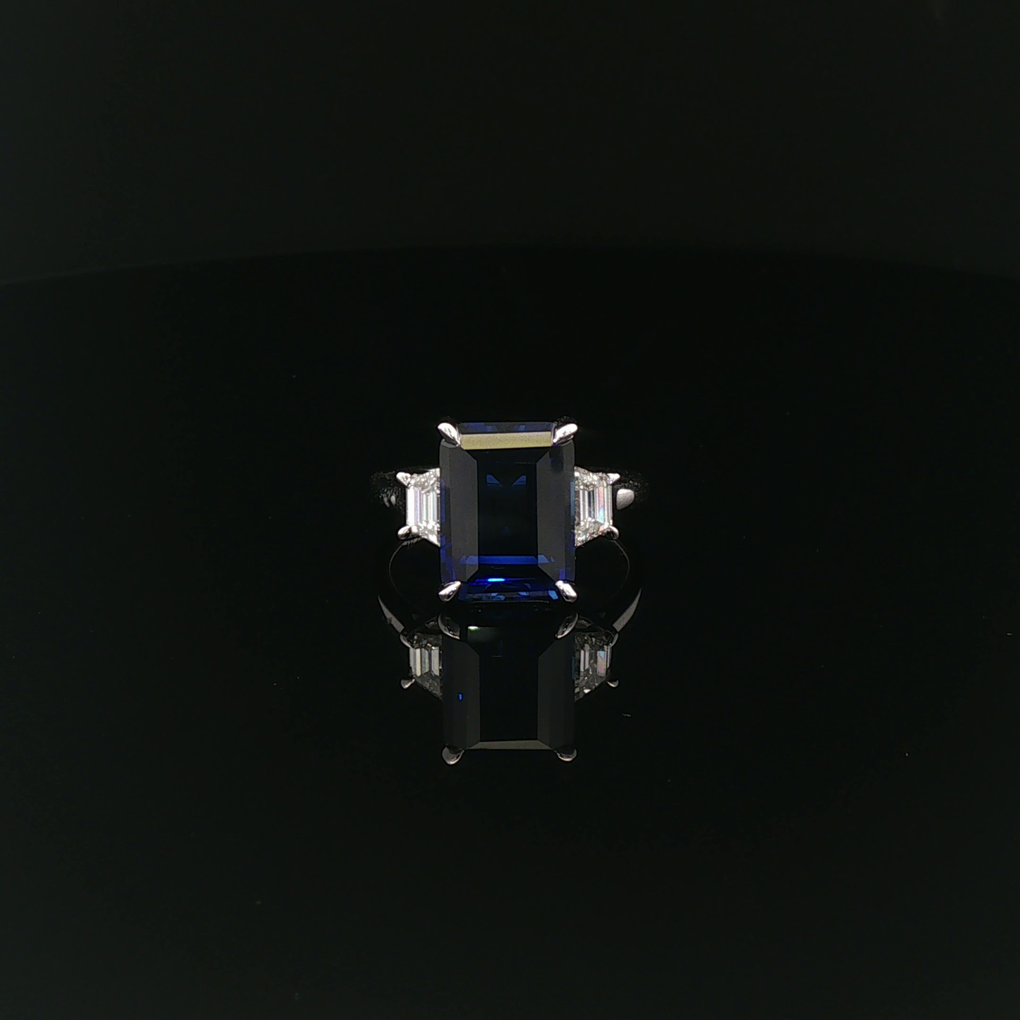 Emerald 6.98ct Royal Blue Sapphire with 40pt each Trapezoid 18k/W