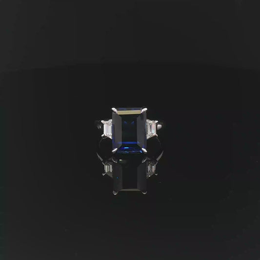 Emerald 6.98ct Royal Blue Sapphire with 40pt each Trapezoid 18k/W