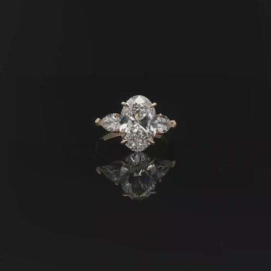 IGI Oval 3.07ct D VS1 18K/Y with 0.3ct pear each side